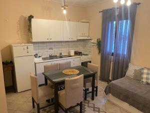 a small kitchen with a table and a kitchen with a couch at Της κυρα Τασιας in Konitsa