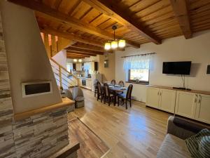 a kitchen and living room with a table and a television at Slnečný dvor Bukovinka in Dravce