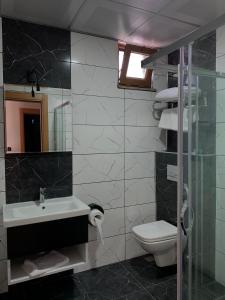 a bathroom with a sink and a toilet and a window at Mitra Black Sea in Arhavi +3 photos