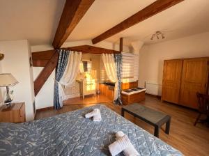 a bedroom with a bed with two towels on it at Château Borie Neuve in Badens +23 photos