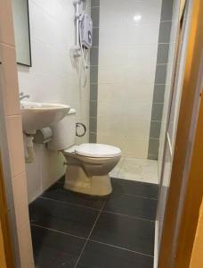 a bathroom with a toilet and a sink at Hotel O Village in Baling +16 photos