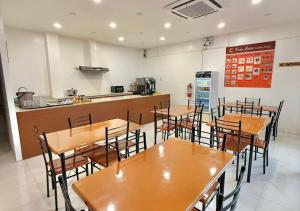 a restaurant with wooden tables and chairs and a counter at Cris Inn Samal in Samal +7 photos