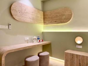 a room with two stools and a counter with wood at Asimmy Hotel in Kampong Gurun +38 photos