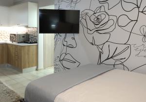 a bedroom with a bed and a wall mural at BeCozy in Thérissos