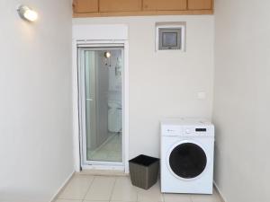 a washer and dryer in a room with a toilet at BeCozy in Thérissos