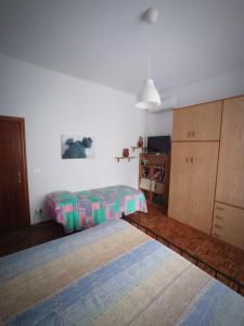 a bedroom with a bed and a dresser at La Ceramica in Appignano