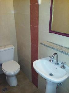 a bathroom with a toilet and a sink at Hotel Wilton in Mar del Plata