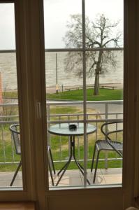 a view of a table and chairs from a window at Nidos burė in Nida