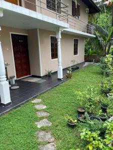 a front yard of a house with a walkway at Ciel Grand 99 Villa in Katugastota
