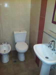 a bathroom with a toilet and a sink at Hotel Wilton in Mar del Plata