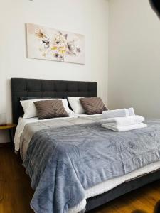 a bedroom with a large bed with a blue comforter at Il terrazzino in Ceprano