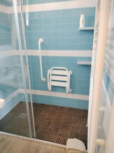 a bathroom with a shower with a bench in it at CASCINA PONTETTO in Asti