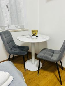 a table with two chairs and a table with a bowl on it at Il terrazzino in Ceprano