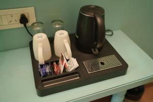 a counter with a coffee pot on a table at Artistik Abode by Stay Banaras in Varanasi