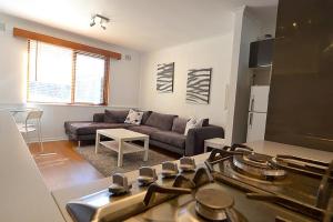 a living room with a couch and a stove at Alpine Haven 5 in Mount Hotham