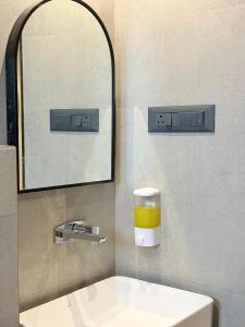 a bathroom with a sink and a glass of orange juice at Hotel Avenue Inn in Navi Mumbai