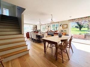 a kitchen and dining room with a table and chairs at Cottage Farm by The Suffolk Cottage Collection in Offton