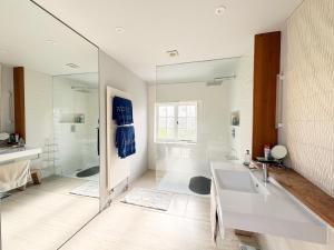 a bathroom with a tub and a sink and a mirror at Cottage Farm by The Suffolk Cottage Collection in Offton +28 photos