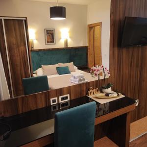 a bedroom with a bed and a table with chairs at Apartments Villa Kresic in Neum