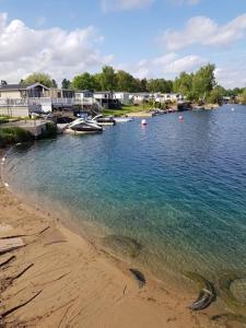 a body of water with boats on the shore at 26 The Meadows in Tattershall