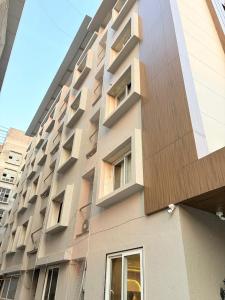 a tall building with windows on the side of it at Hotel Avenue Inn in Navi Mumbai +17 photos