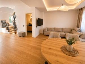 a living room with a table and a couch at Da Vinci Luxury Home Otopeni in Otopeni
