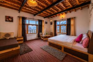 a bedroom with a bed and two windows at Pema's Cottage by Outback Escapes in Kaza