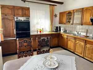 a kitchen with wooden cabinets and a plate on a table at Haus Anne und Peter in Fischbach