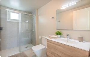 a bathroom with a shower and a toilet and a sink at El Rincón del Charco in Arrecife +11 photos
