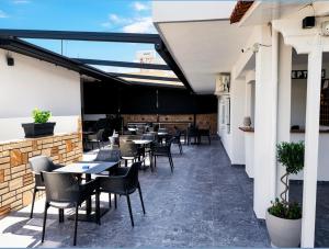 a row of tables and chairs on a patio at Hotel Elite in Ksamil