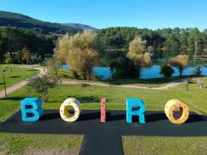 a sign for a park with a lake in the background at AG Apartamentos BoiroBello 2 in Boiro