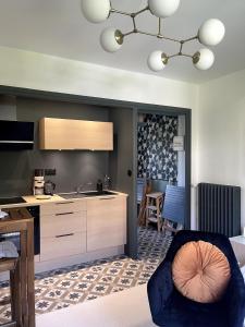a kitchen with a sink and a counter at L'instant cocon in Beaumont