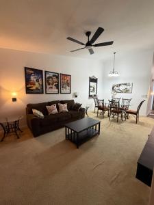 a living room with a couch and a table at Cozy Disney Stay in Kissimmee