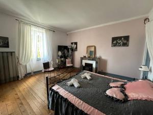 a bedroom with a large bed with pillows on it at Château Borie Neuve in Badens
