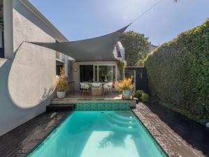 a swimming pool in the backyard of a house at Hout Bay Gem 61 Milner in Hout Bay +12 photos