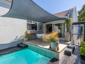 a house with a swimming pool and a patio at Hout Bay Gem 61 Milner in Hout Bay