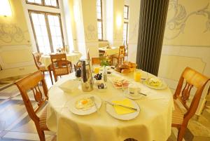 a table with plates of food on it in a restaurant at Hotel Börse in Görlitz