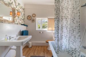 a bathroom with a sink and a shower curtain at Bon Chez Nous in Saint-Amand-Jartoudeix +79 photos