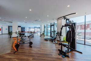 a gym with treadmills and machines in a building at Apartments in Navi in Gonio