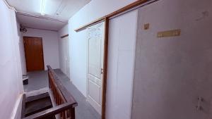 an empty room with a door and a hallway at Pink Kraken Hostel in Ban Nong Chaeng +22 photos