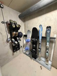 a group of snowboards and ski equipment hanging on a wall at Morzine Centre Apartment 1 min from Super M in Morzine