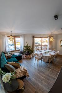 a living room with a long table and chairs at Morzine Centre Apartment 1 min from Super M in Morzine