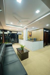 a living room with a couch and a table at Sri Sai Saara Inn in Bangalore