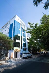 a building with a car parked in front of it at Sri Sai Saara Inn in Bangalore