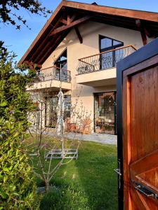 a house with a tree in front of it at Abant Cozy Homes in Bolu