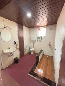 a bathroom with a sink and a toilet at Lilly Beach House in Kīhīm +7 photos
