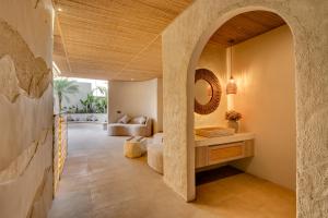 an archway leads into a living room with a couch at Premaloka in Tanah Lot +84 photos