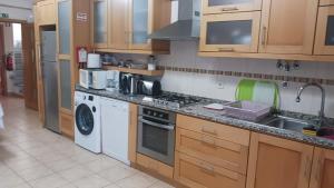 a kitchen with a sink and a stove top oven at Casa do Adro in Arcozelo