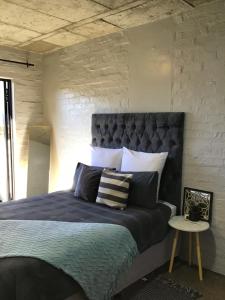 a bedroom with a large bed with a headboard at Home at heart in Johannesburg