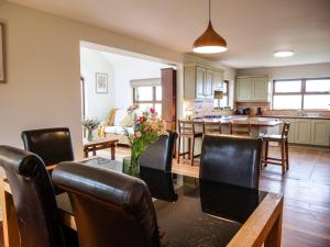 a kitchen and dining room with a table and chairs at Just Beyond Dingle in Dingle